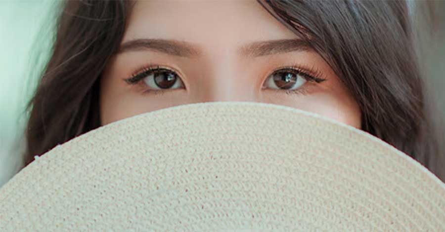 Asian woman with beautiful eyes looking straight at the camera.