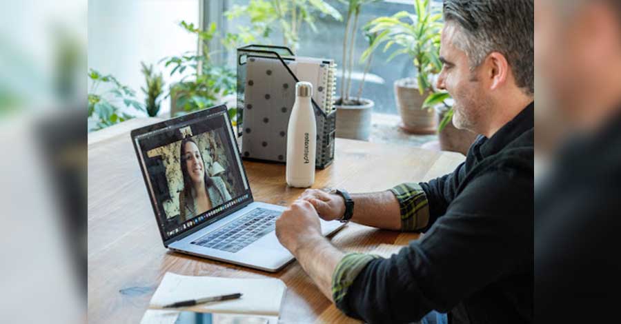 A man having a video call with a Latina.