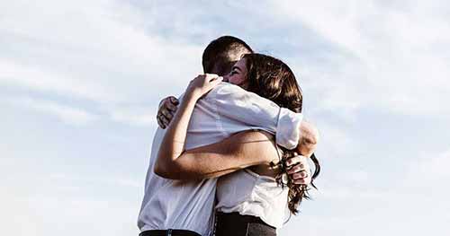 A photo of a man and a woman hugging each other